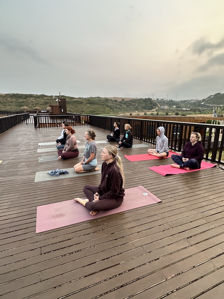 Group meditation on the rooftop deck at a Monkey Mind retreat, Portugal